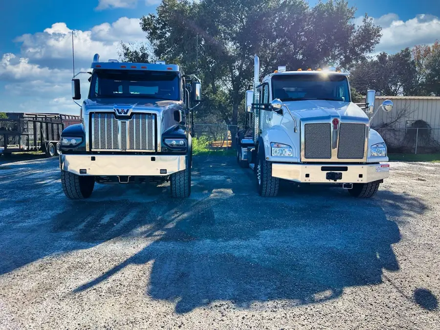 Two Alamo Disposal roll-off trucks
